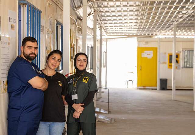 Duha and her colleagues pose together for a photo outside of the IRC's medical clinic in the Za'atari refugee camp.